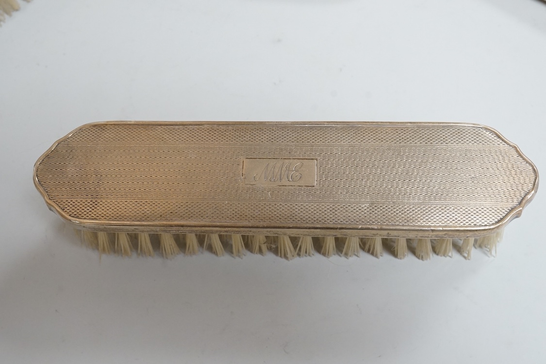 An early 1960's silver mounted hand mirror, 24.7cm and two matching brushes, Adie Bros. Birmingham, 1960.